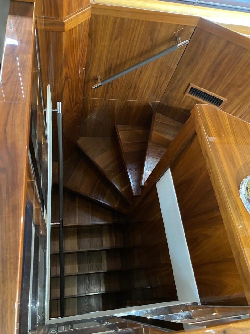 a staircase with a glass case aboard RIII Yacht for Sale