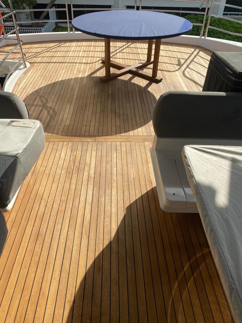 a table and chairs on a deck aboard RIII Yacht for Sale