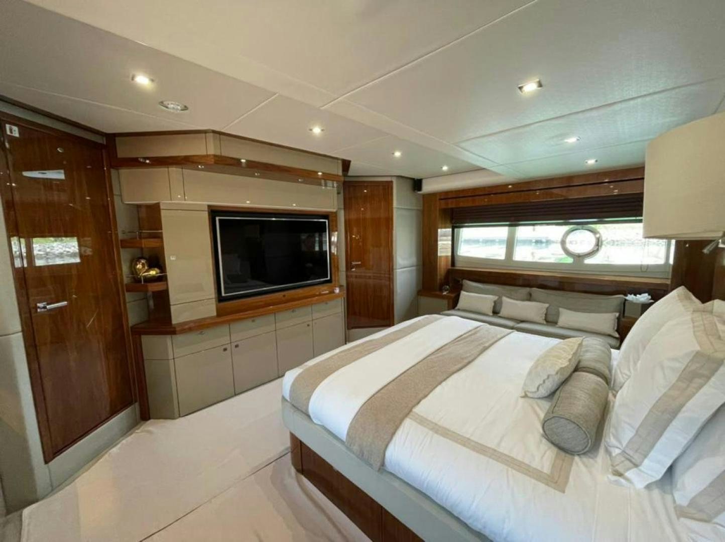 a bedroom with a bed and a television aboard RIII Yacht for Sale