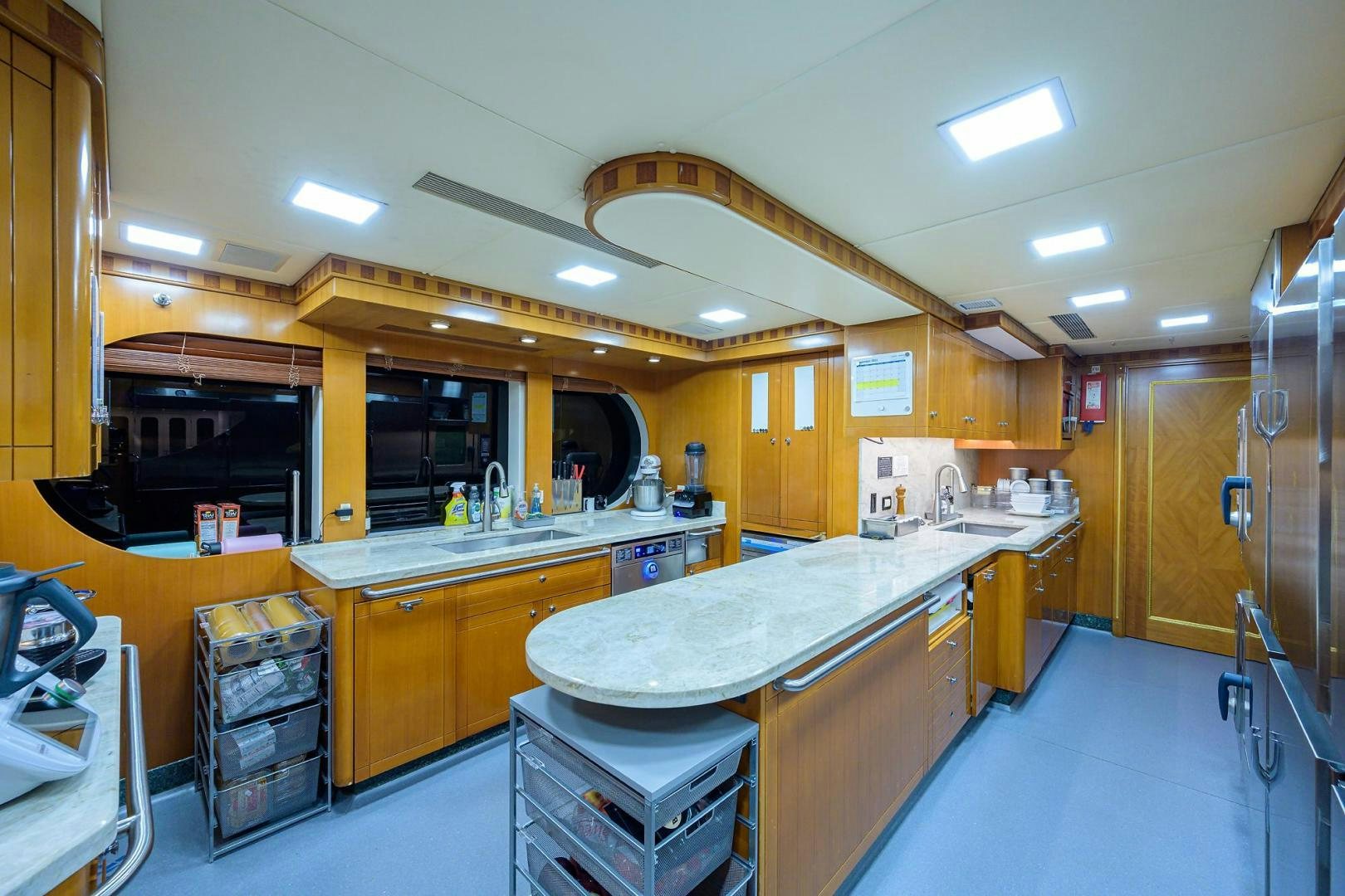 a kitchen with wooden cabinets aboard STARSHIP Yacht for Sale