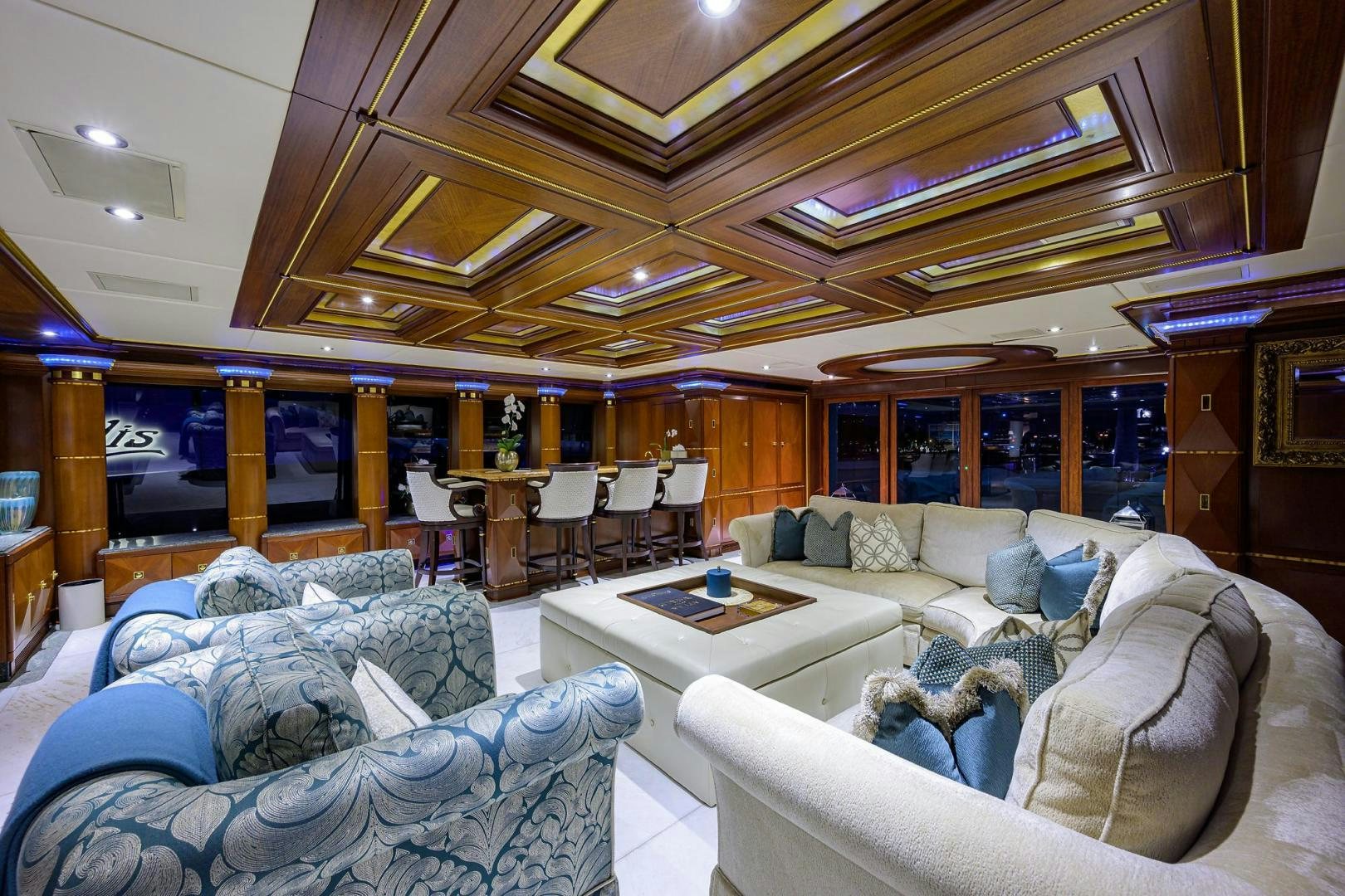 a living room with a large glass wall aboard STARSHIP Yacht for Sale