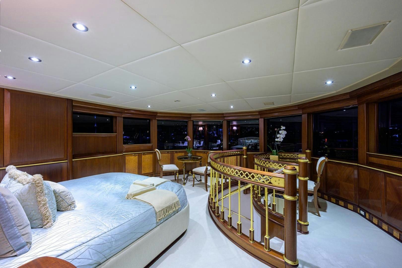 a room with a bed and a table aboard STARSHIP Yacht for Sale