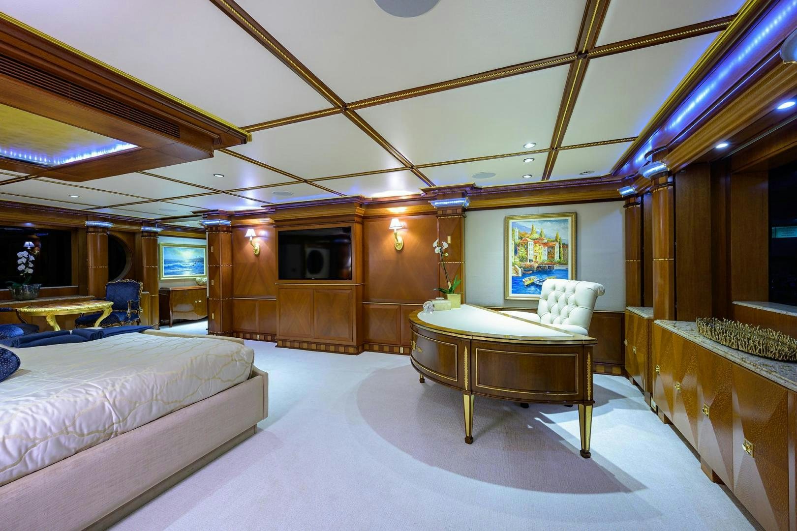 a room with a table and couch aboard STARSHIP Yacht for Sale