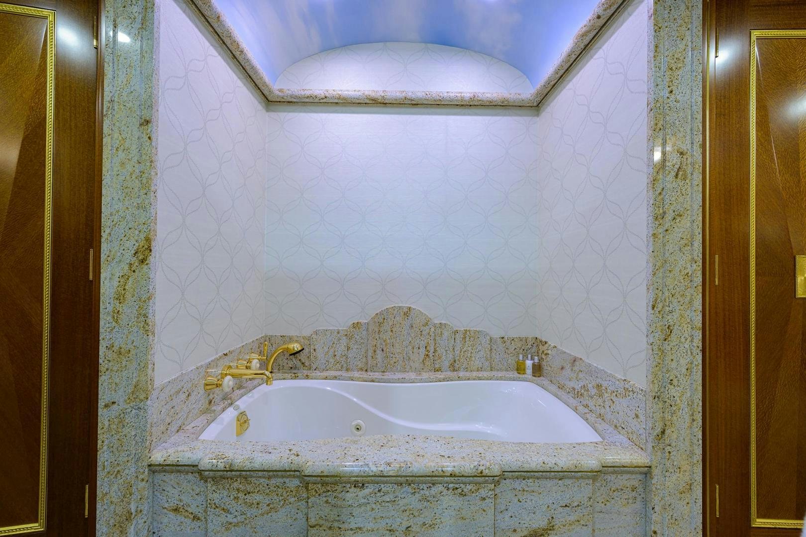 a bathtub in a bathroom aboard STARSHIP Yacht for Sale