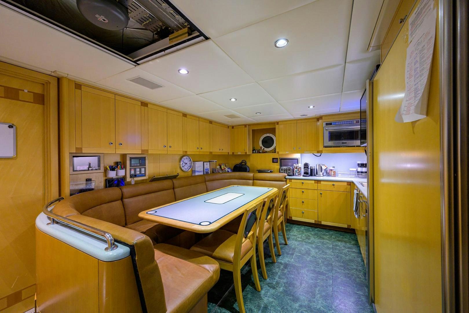 a kitchen with a table and chairs aboard STARSHIP Yacht for Sale