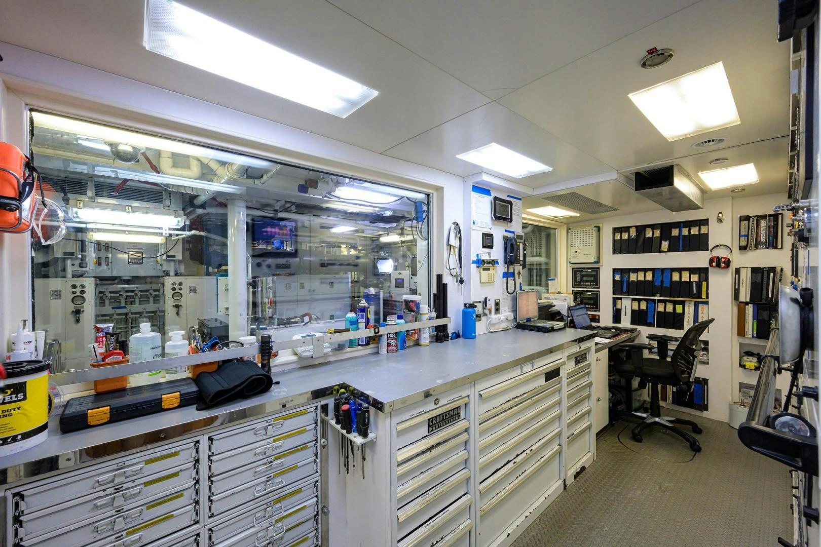 a room with shelves and a chair aboard STARSHIP Yacht for Sale