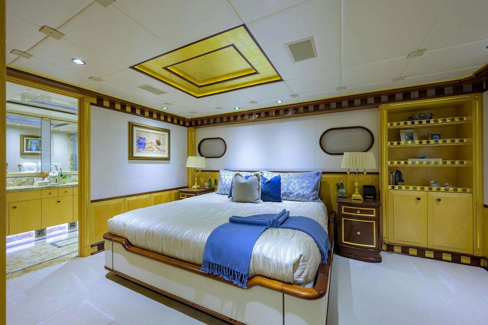 a bedroom with a bed and a desk aboard STARSHIP Yacht for Sale