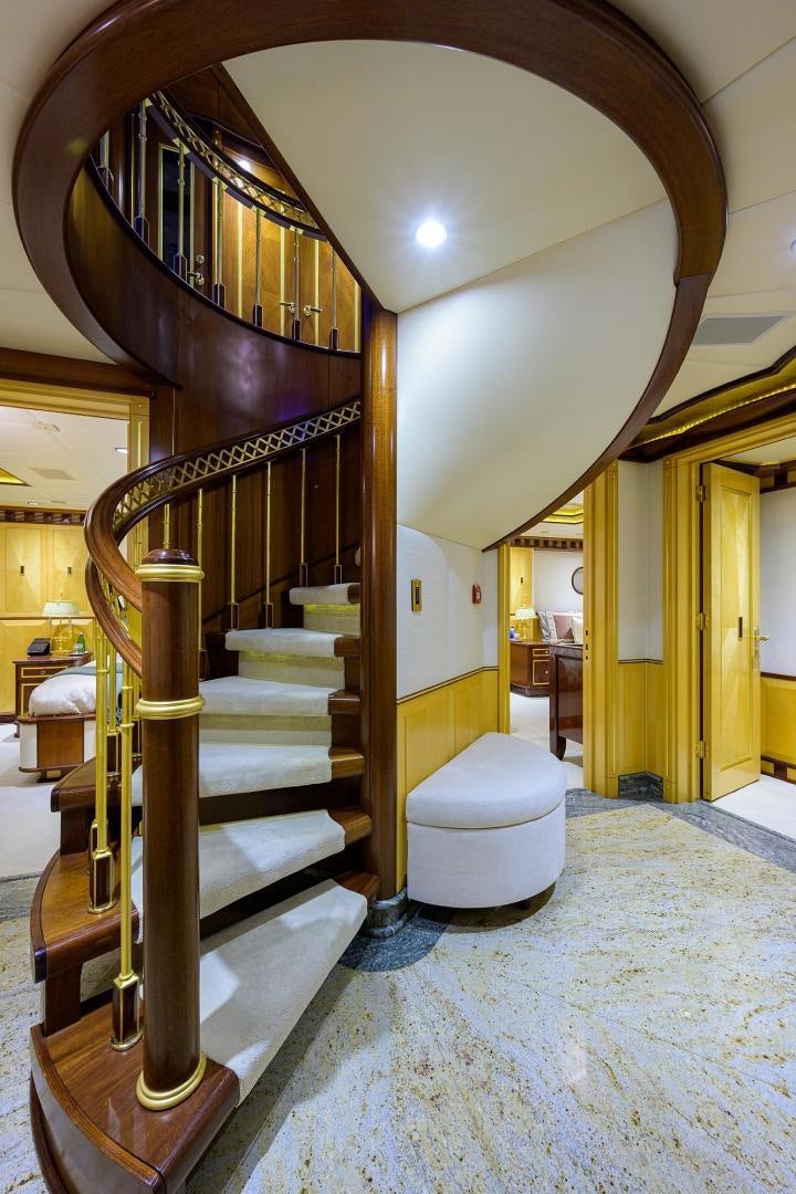 a large staircase with a chandelier aboard STARSHIP Yacht for Sale