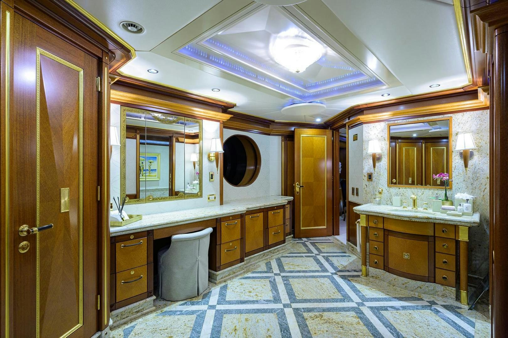 a bathroom with a large blue tile floor aboard STARSHIP Yacht for Sale