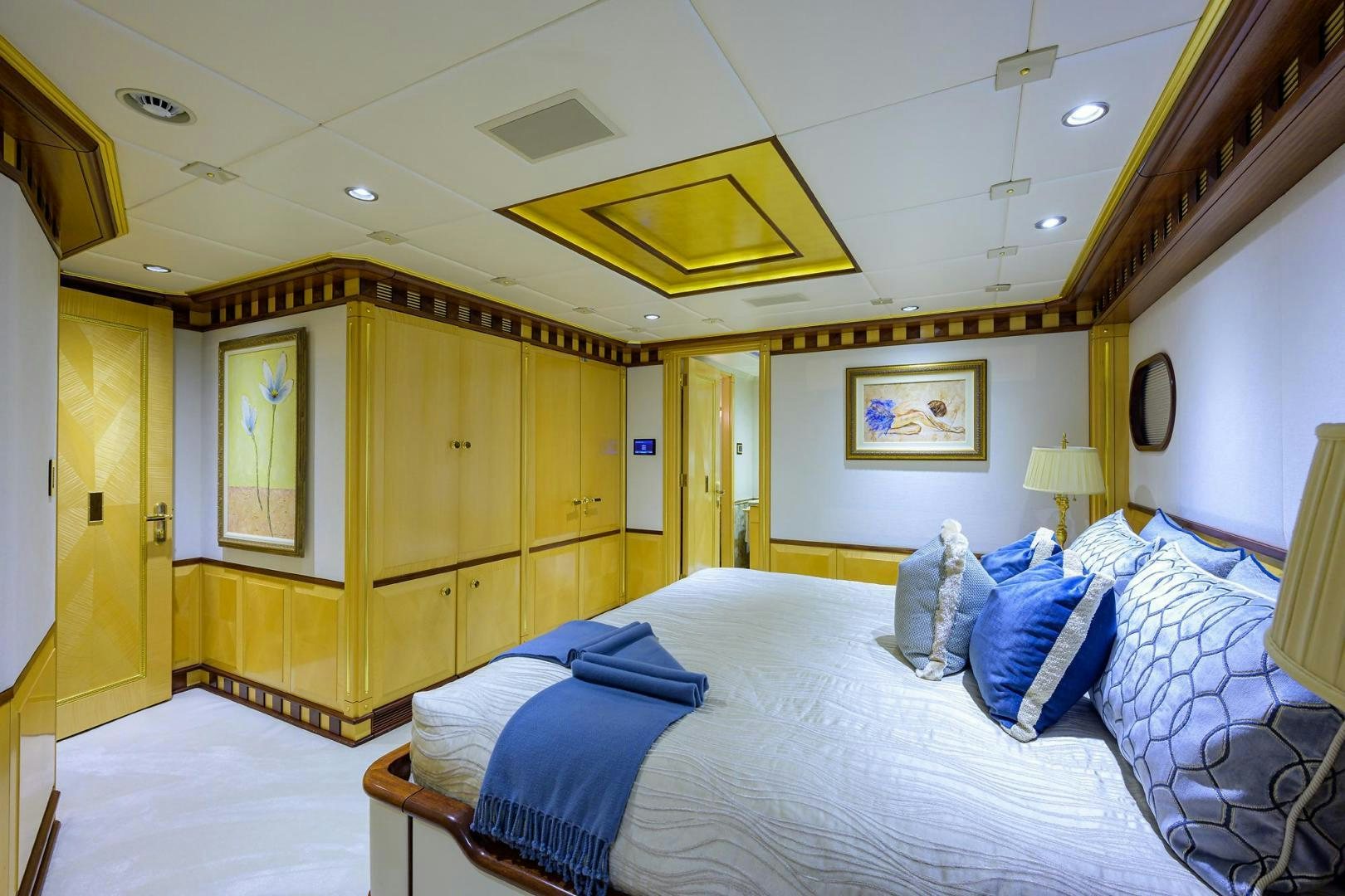 a bedroom with a bed and a wood closet aboard STARSHIP Yacht for Sale