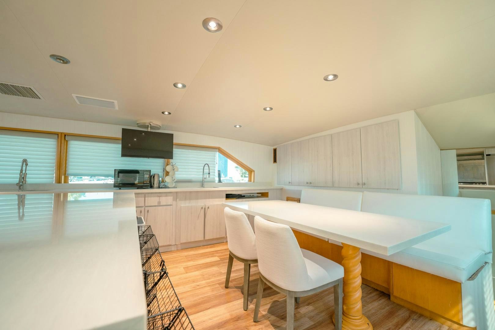 a kitchen with a table and chairs aboard ALEXANDRA JANE Yacht for Sale