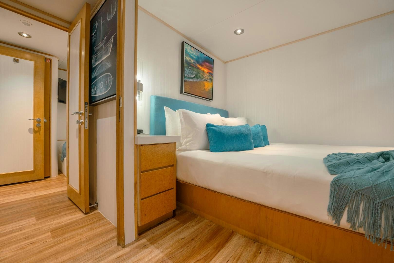 a bedroom with a bed and a door aboard ALEXANDRA JANE Yacht for Sale