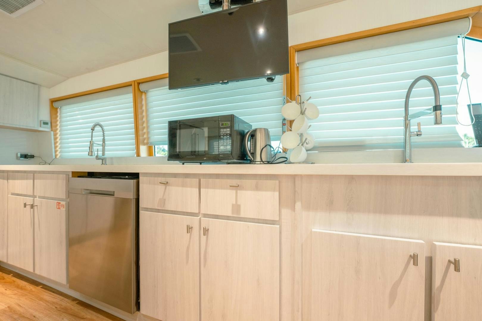 a kitchen with wooden cabinets aboard ALEXANDRA JANE Yacht for Sale
