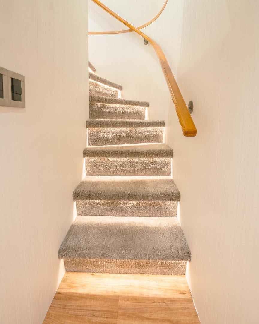a set of stairs with a wood handle aboard ALEXANDRA JANE Yacht for Sale