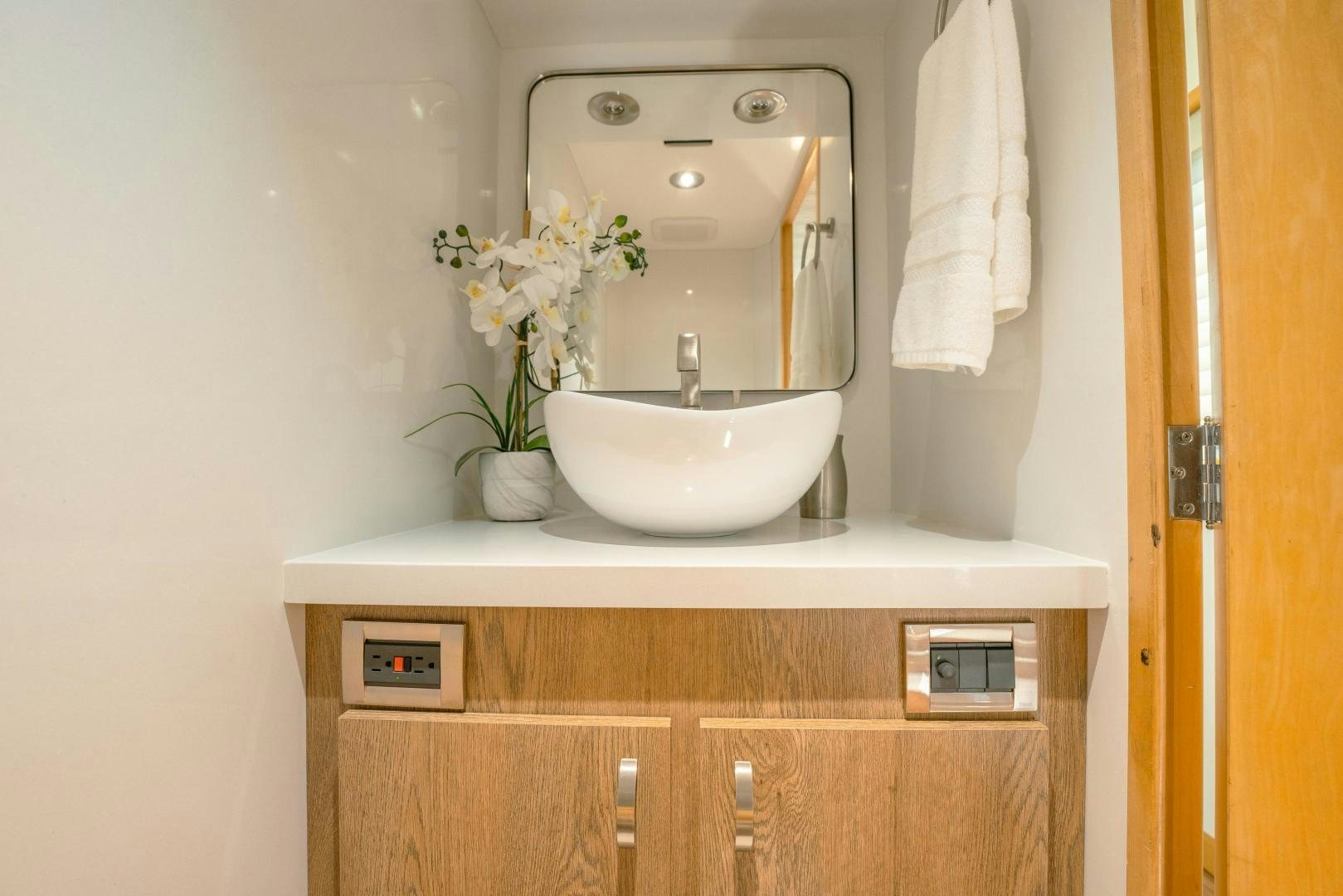 a bathroom with a sink and mirror aboard ALEXANDRA JANE Yacht for Sale