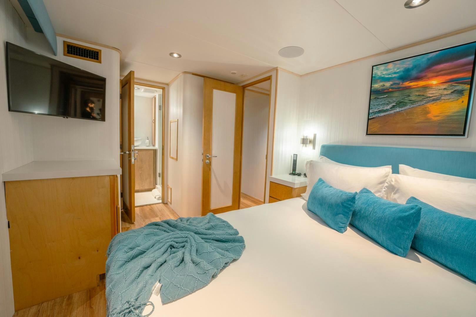 a bedroom with a blue bed spread aboard ALEXANDRA JANE Yacht for Sale