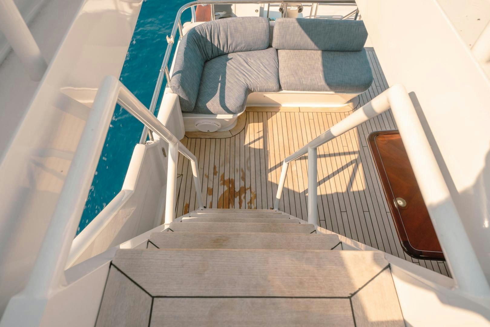 a set of stairs leading up to a room with a couch and a wood door aboard ALEXANDRA JANE Yacht for Sale