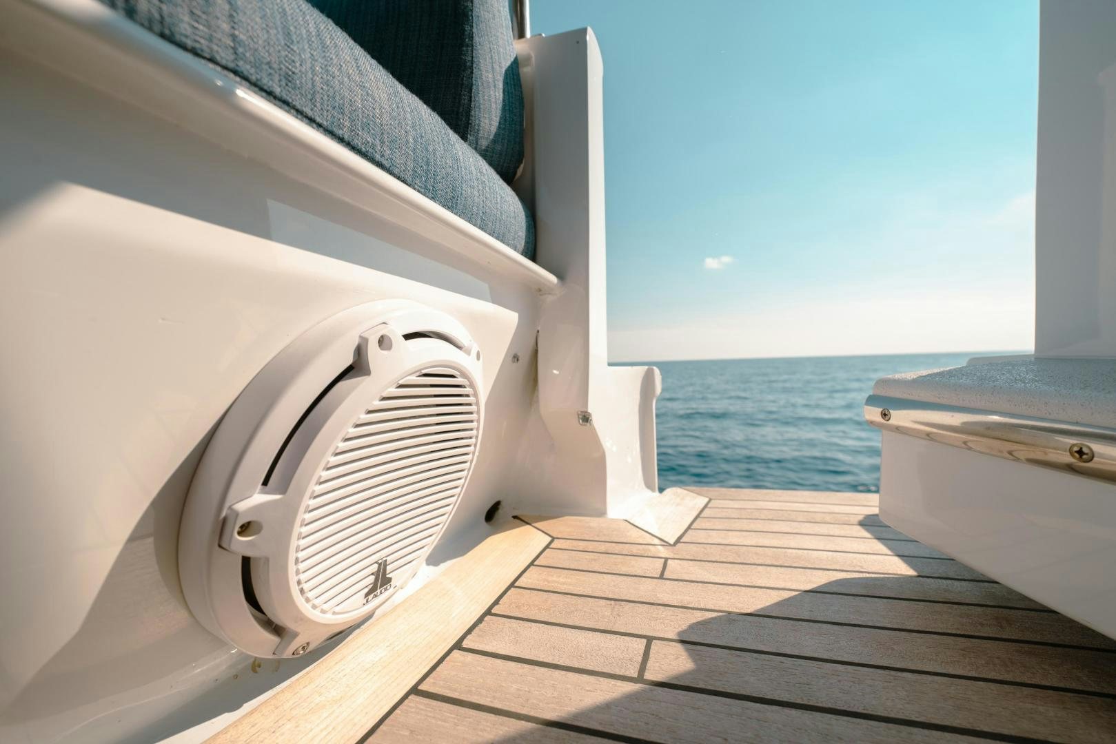 a white circular object on a wooden surface next to a body of water aboard ALEXANDRA JANE Yacht for Sale