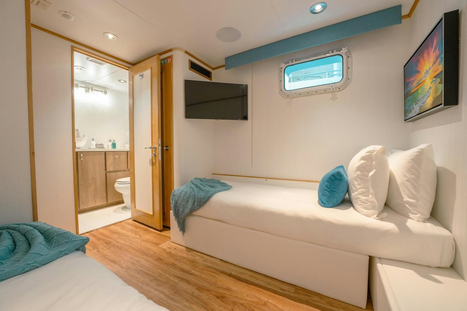 a room with a bed and a television on the wall aboard ALEXANDRA JANE Yacht for Sale