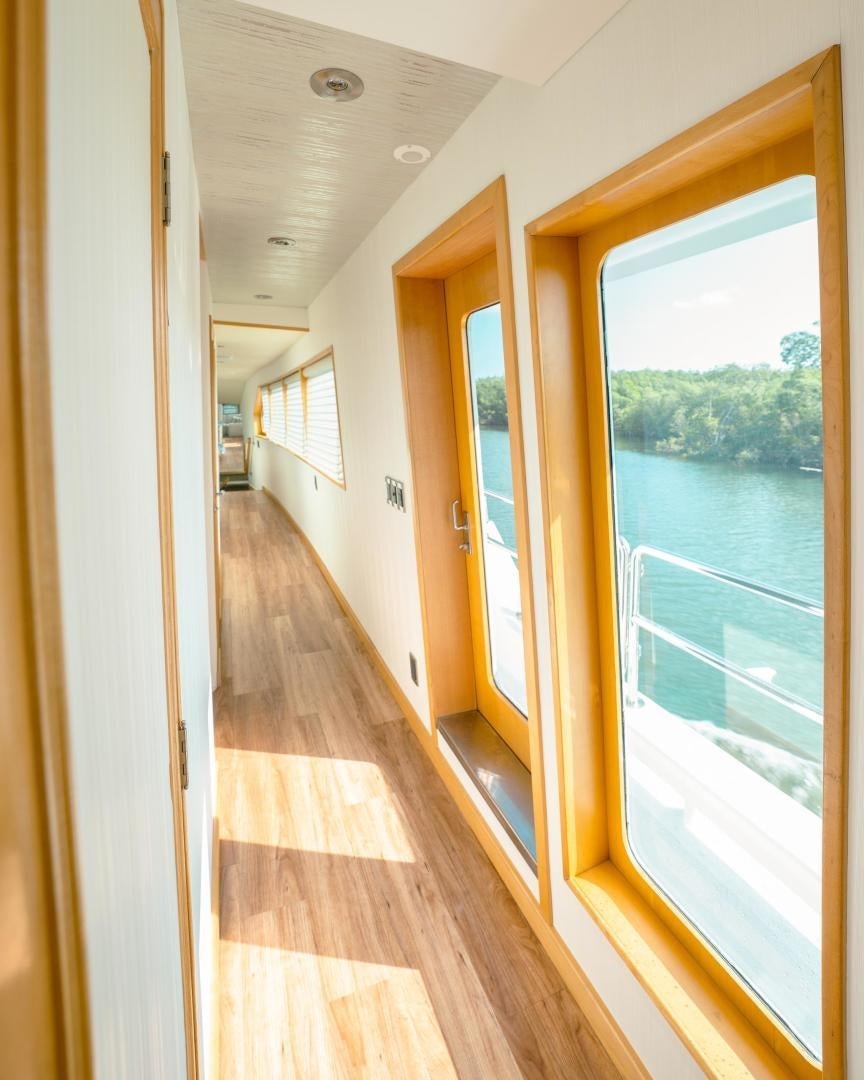 a hallway with a door and a window aboard ALEXANDRA JANE Yacht for Sale