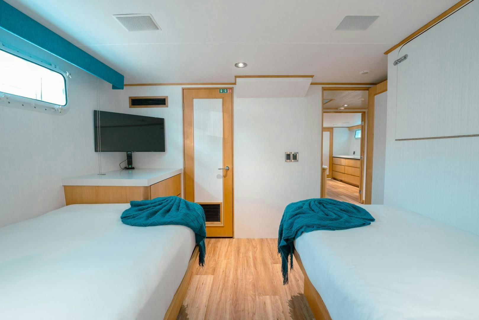 a room with beds and a tv aboard ALEXANDRA JANE Yacht for Sale