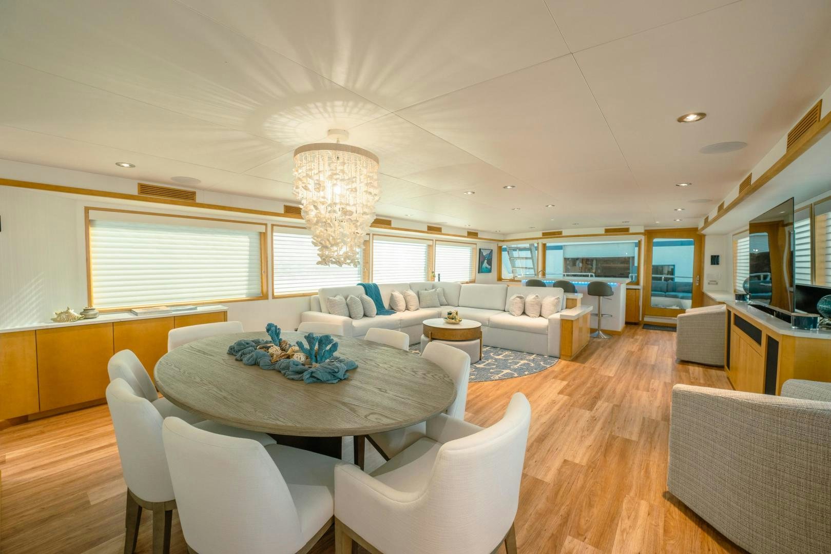a large living room with a large table and chairs aboard ALEXANDRA JANE Yacht for Sale