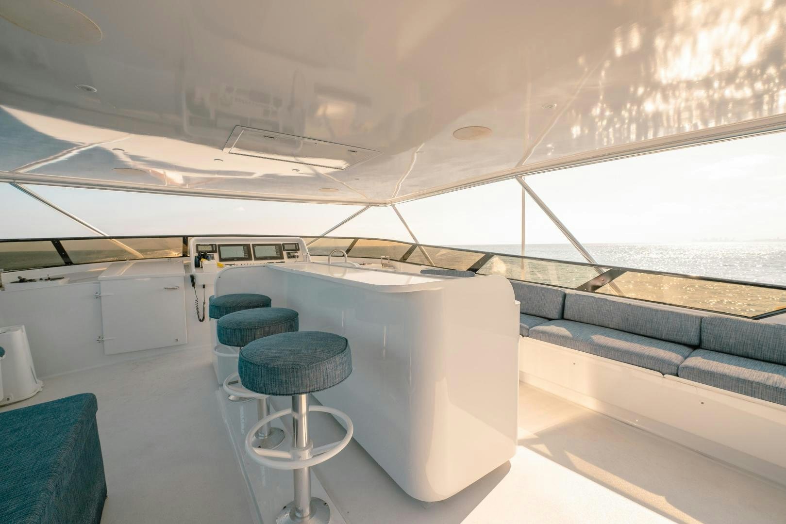 a room with a table and stools aboard ALEXANDRA JANE Yacht for Sale