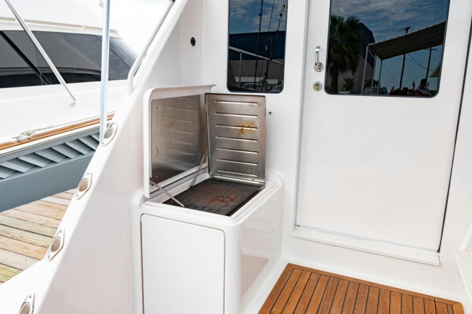 a white boat with a door open aboard Bimini Babe Yacht for Sale