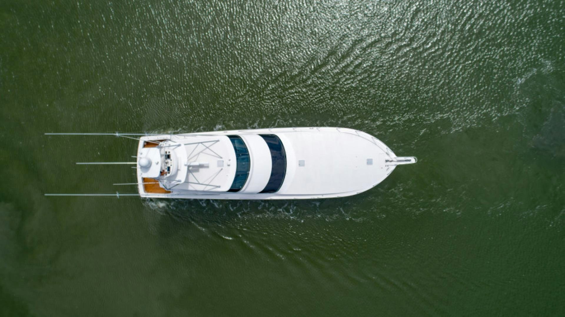 a white and blue sports car in the rain aboard Bimini Babe Yacht for Sale