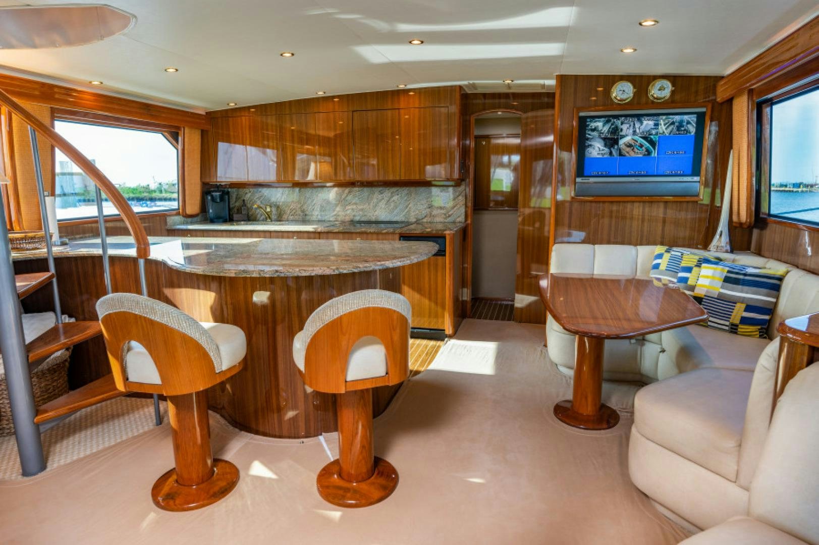 a room with a table and chairs aboard Bimini Babe Yacht for Sale