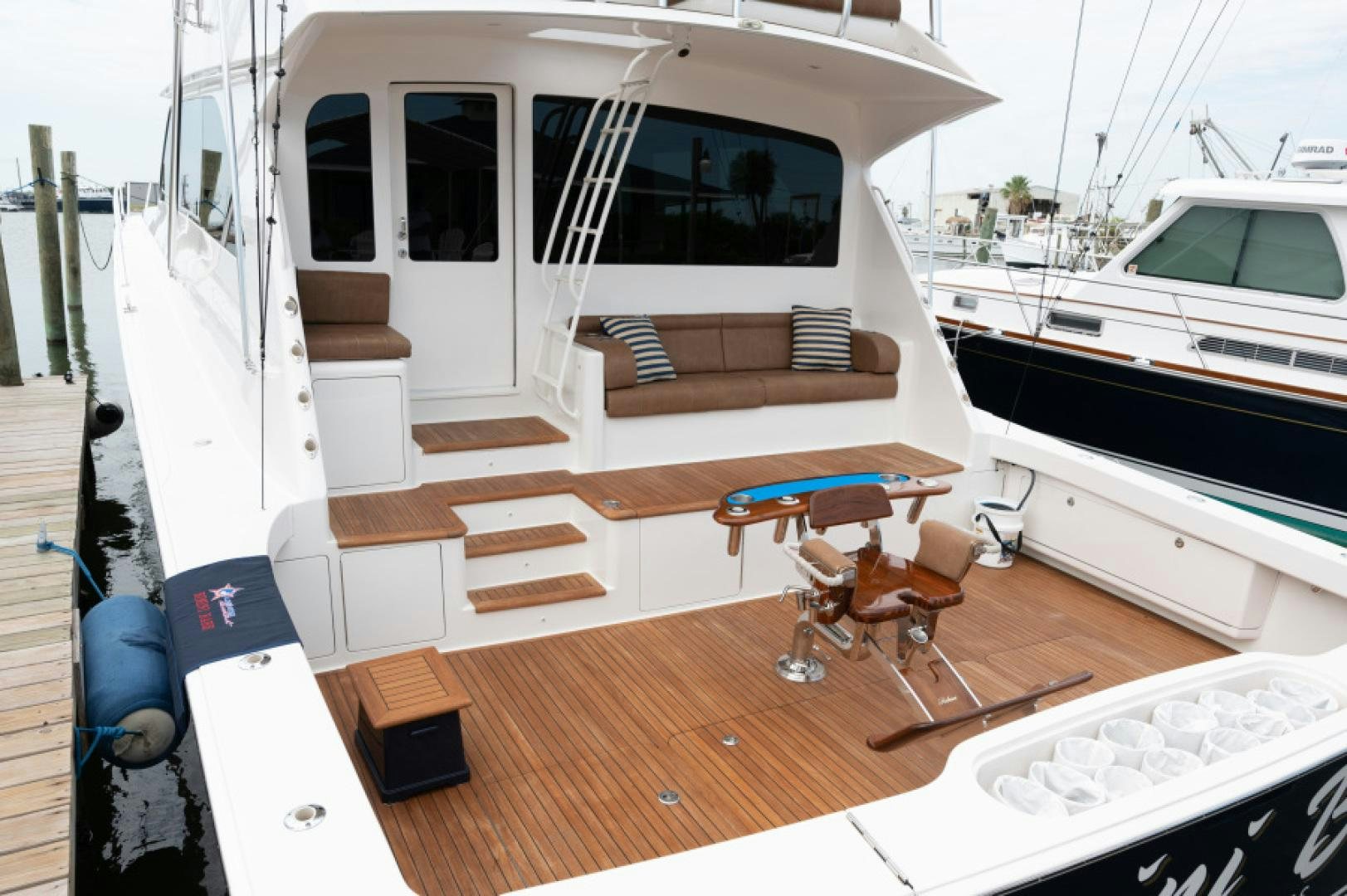 a boat with a wood deck aboard Bimini Babe Yacht for Sale