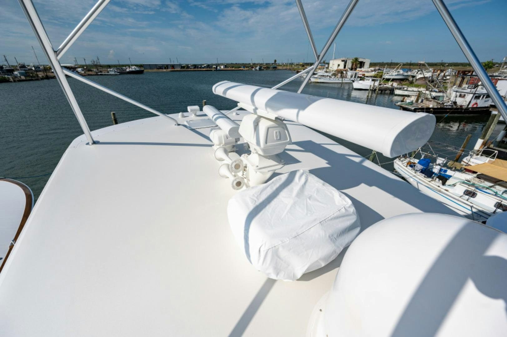 a white boat with a white cover on the front aboard Bimini Babe Yacht for Sale
