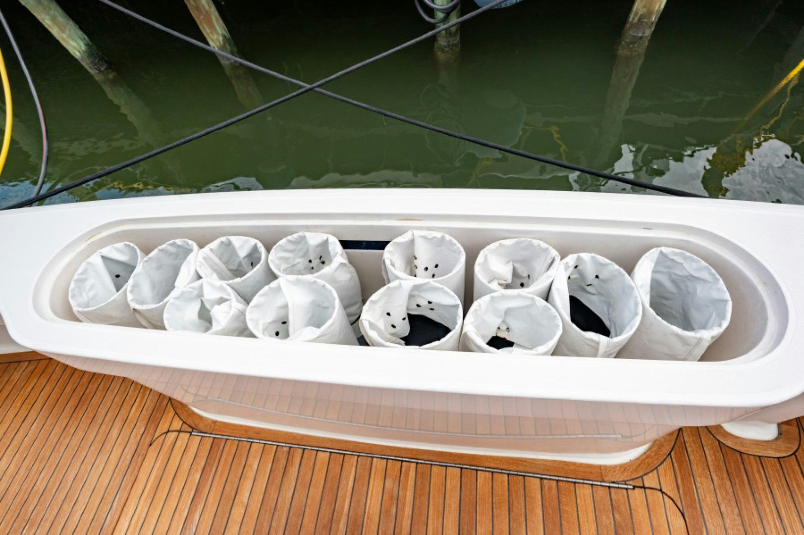a group of white balls in a white container on a wooden surface aboard Bimini Babe Yacht for Sale