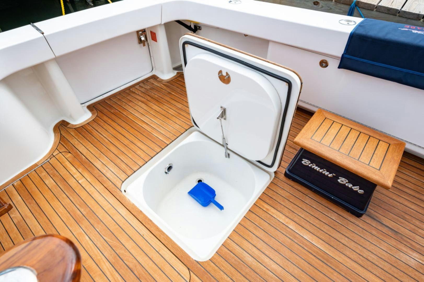 a toilet with a sink and a book on the side aboard Bimini Babe Yacht for Sale