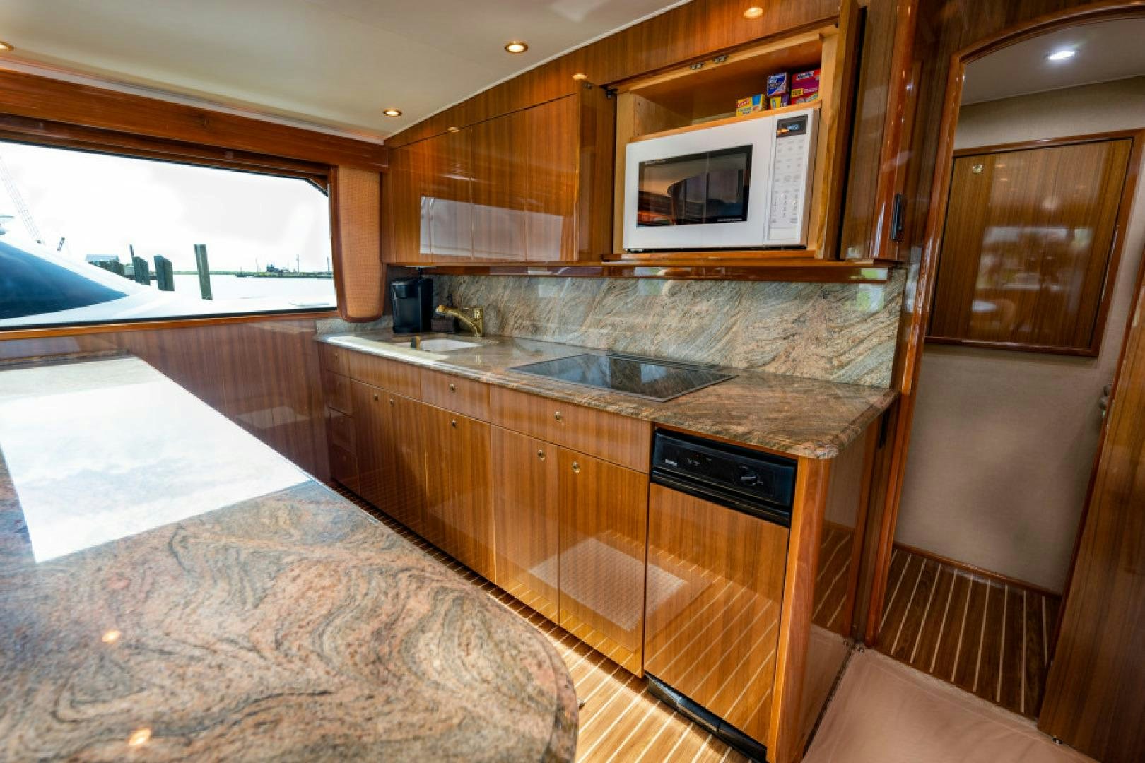 a kitchen with wooden cabinets aboard Bimini Babe Yacht for Sale