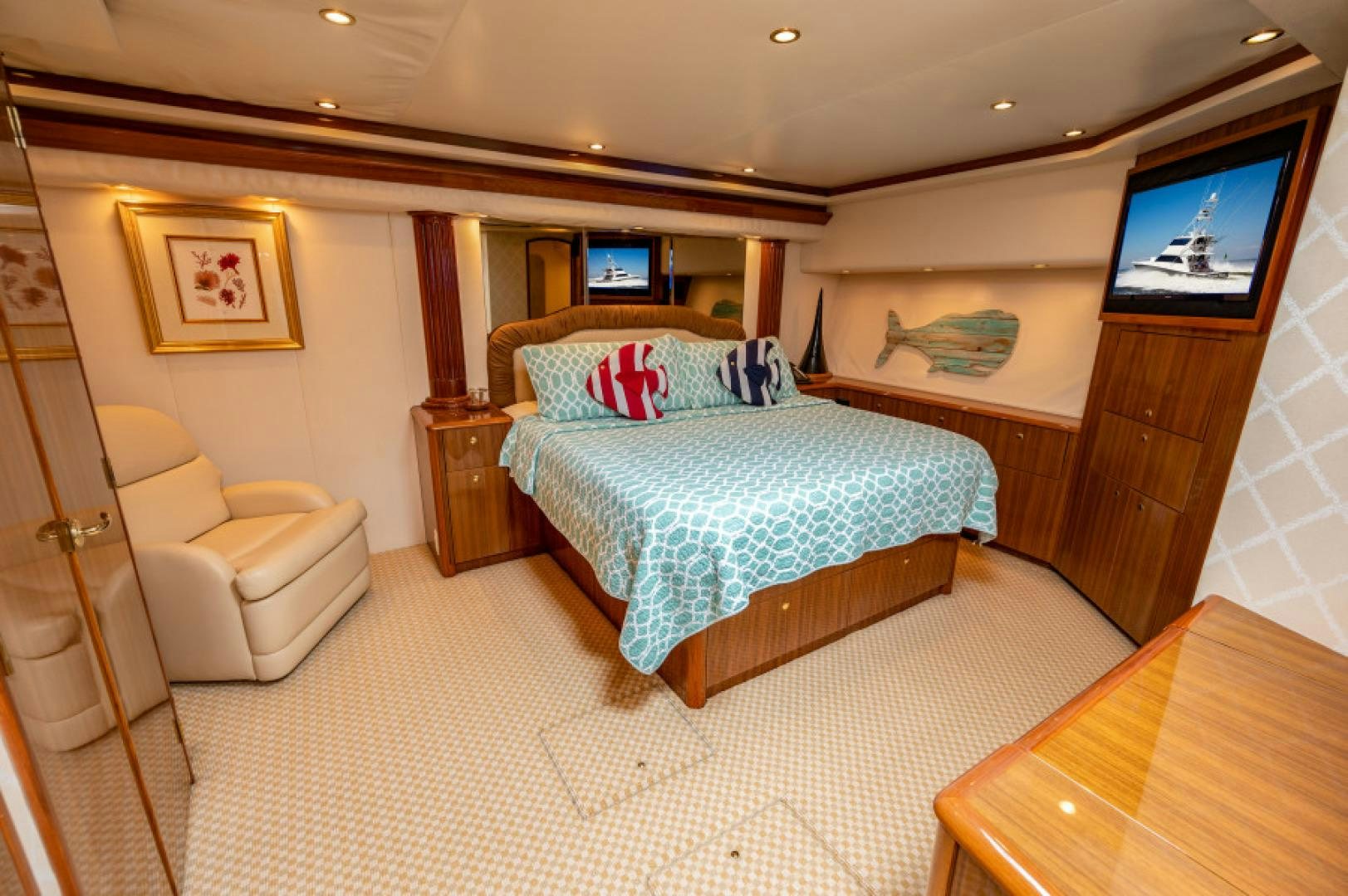 a bedroom with a bed and a television aboard Bimini Babe Yacht for Sale