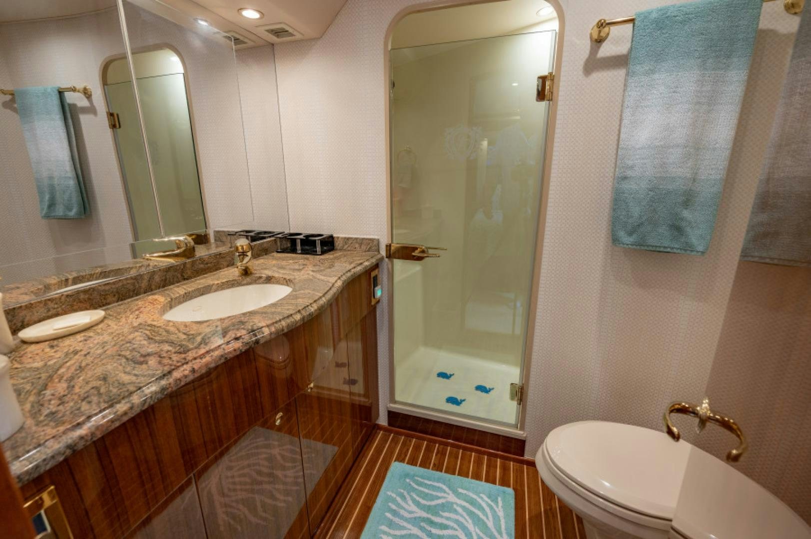 a bathroom with a marble countertop aboard Bimini Babe Yacht for Sale