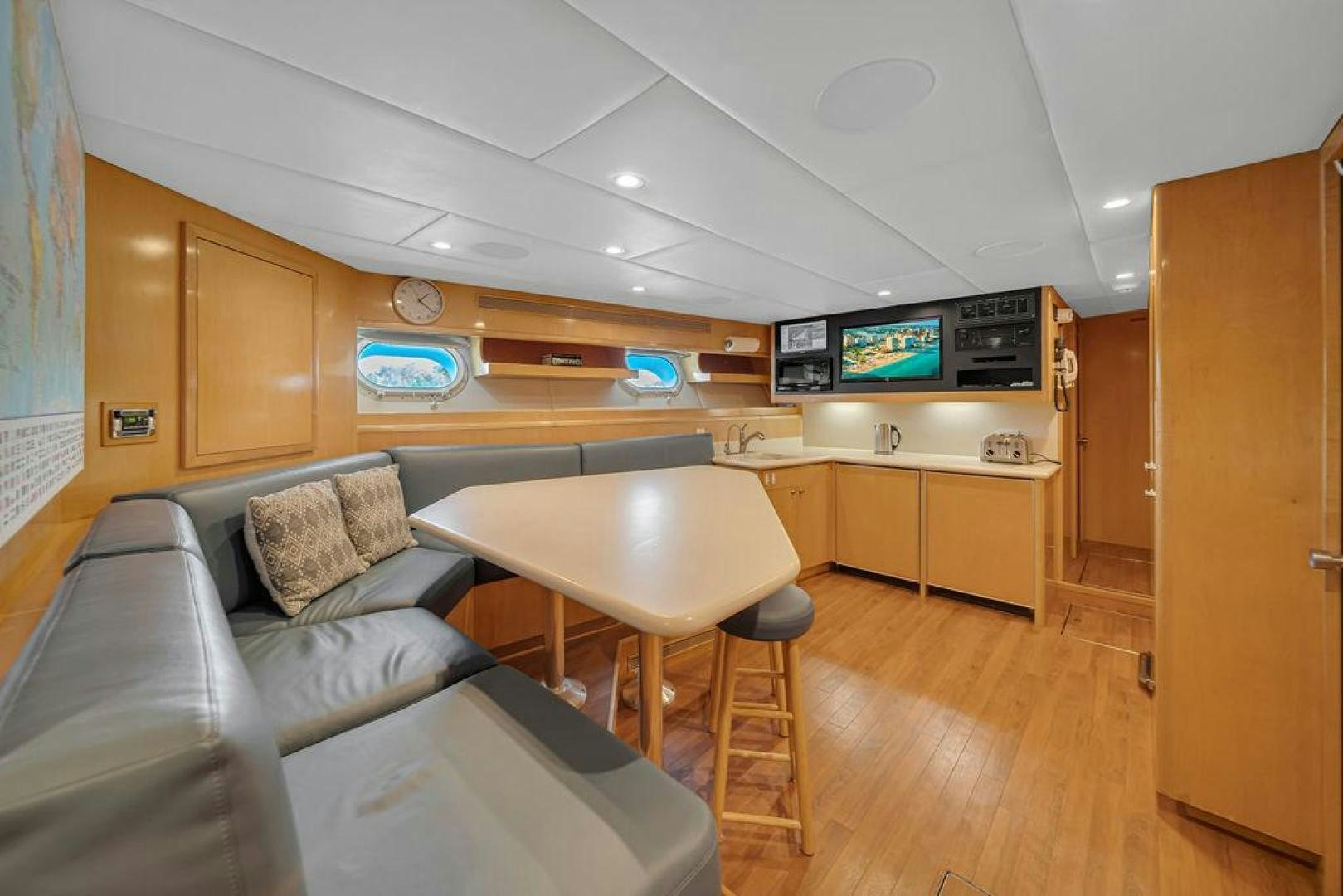 a living room with a couch and a table aboard GRANDEUR Yacht for Sale