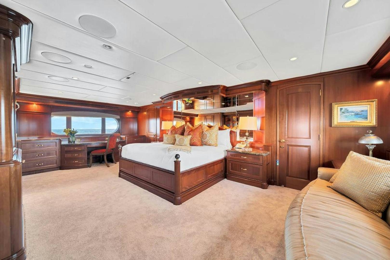a bedroom with a bed and a desk aboard GRANDEUR Yacht for Sale