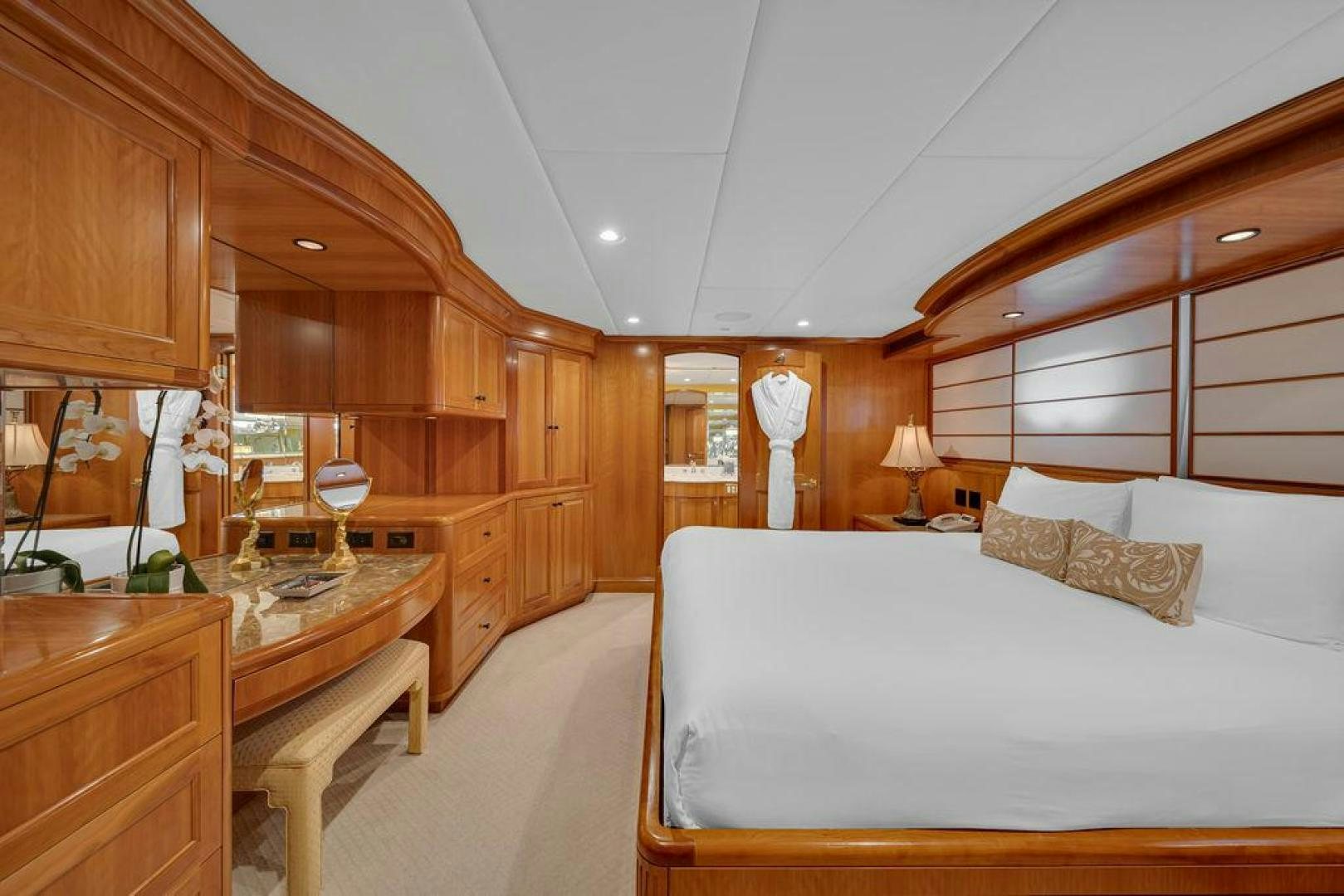 a bedroom with a bed and a desk aboard GRANDEUR Yacht for Sale