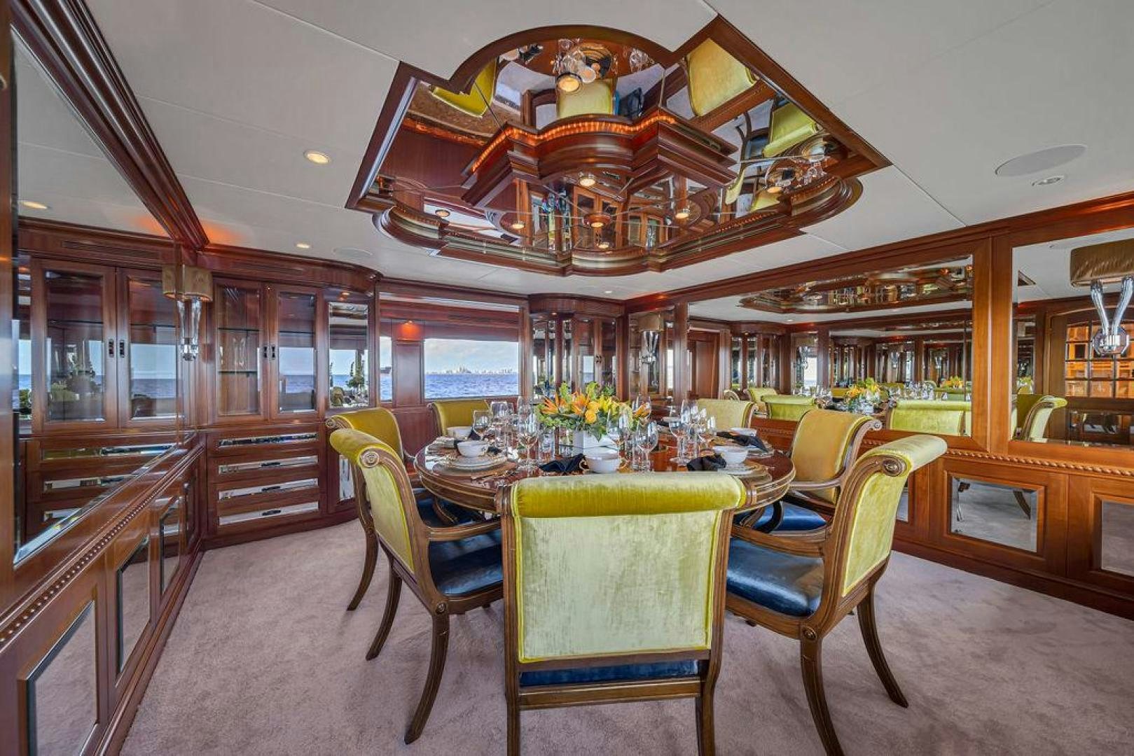 a dining room with a table and chairs aboard GRANDEUR Yacht for Sale