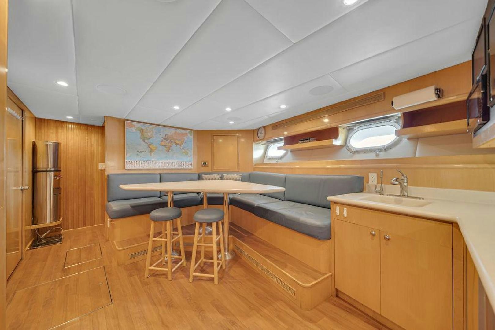 a kitchen with a table and chairs aboard GRANDEUR Yacht for Sale