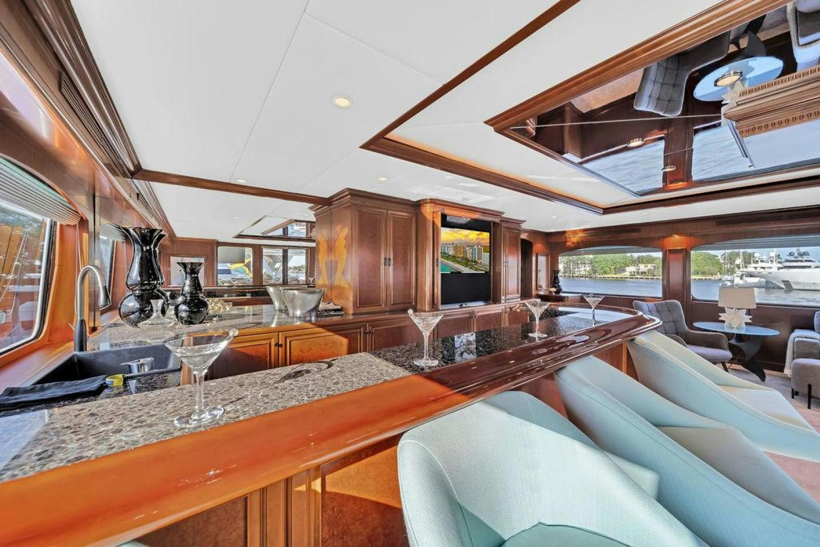 a large room with a bar and a large window aboard GRANDEUR Yacht for Sale