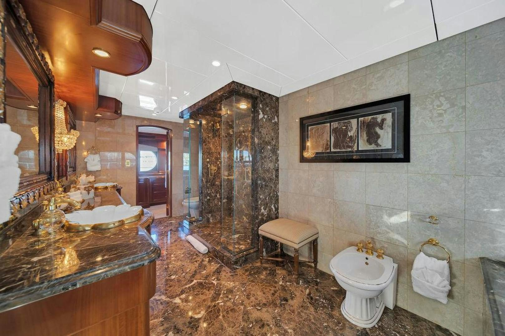 a bathroom with marble tiles aboard GRANDEUR Yacht for Sale
