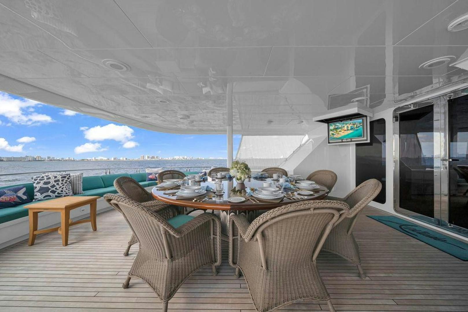 a dining table on a deck aboard GRANDEUR Yacht for Sale