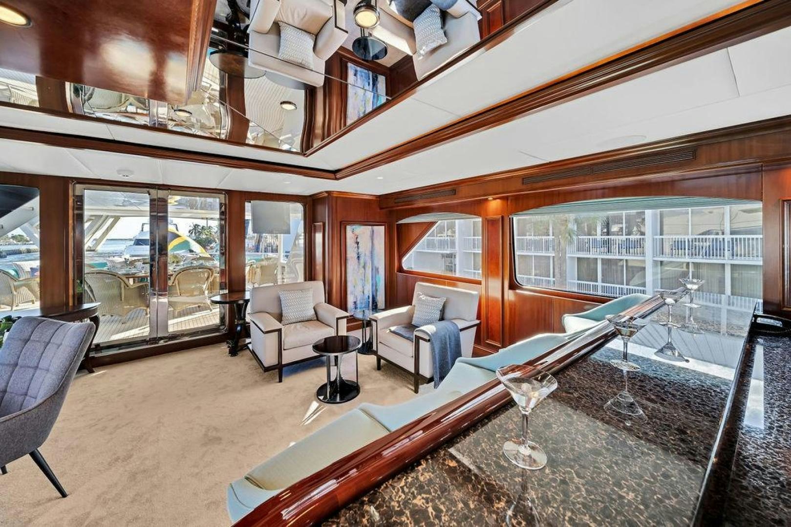 a room with a large window and a table and chairs aboard GRANDEUR Yacht for Sale