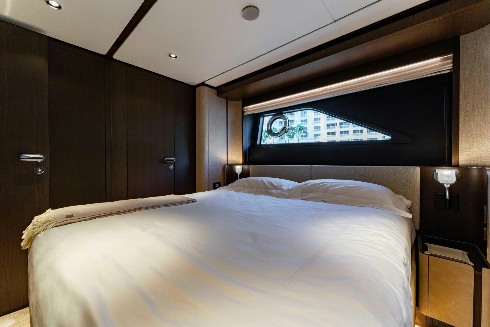 a room with a bed and a television aboard BESO Yacht for Sale