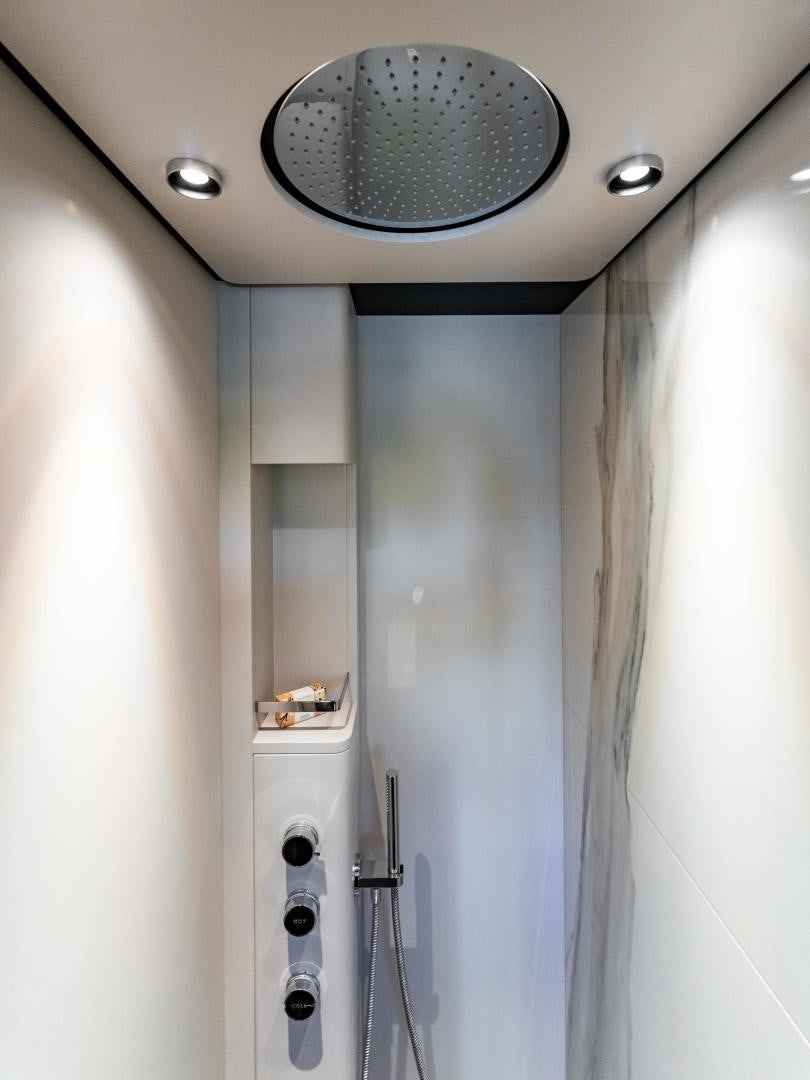 a bathroom with a round mirror aboard BESO Yacht for Sale