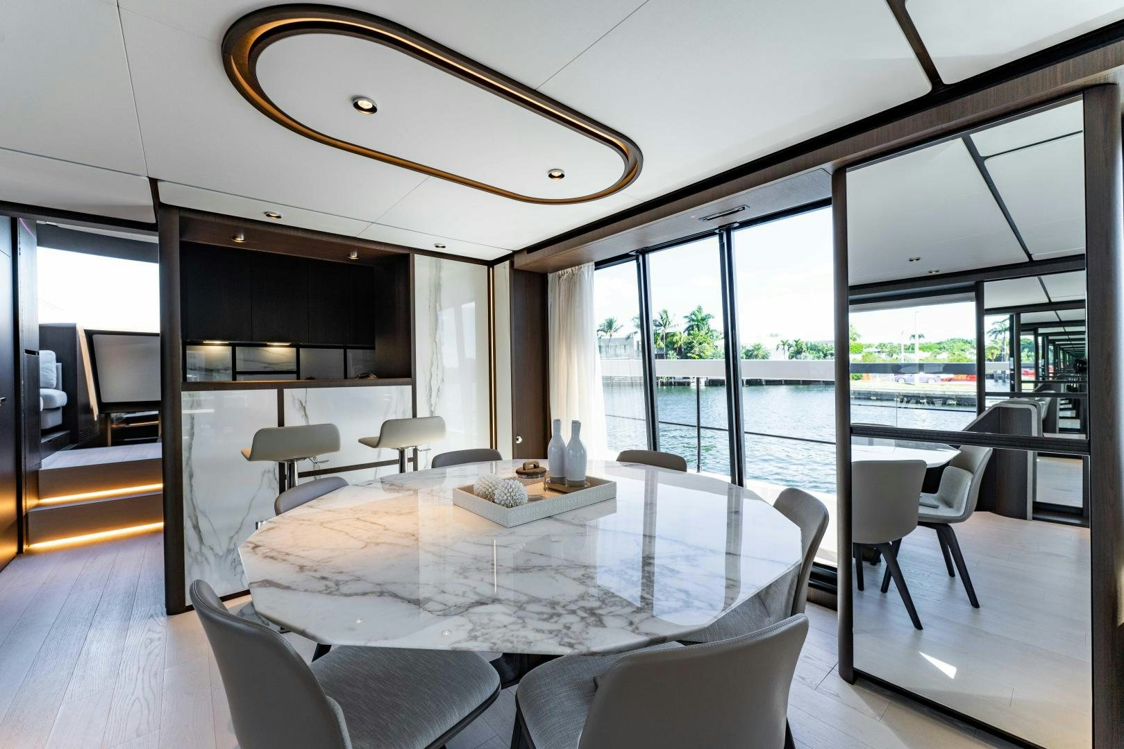 a room with a large table and chairs and a large window aboard BESO Yacht for Sale