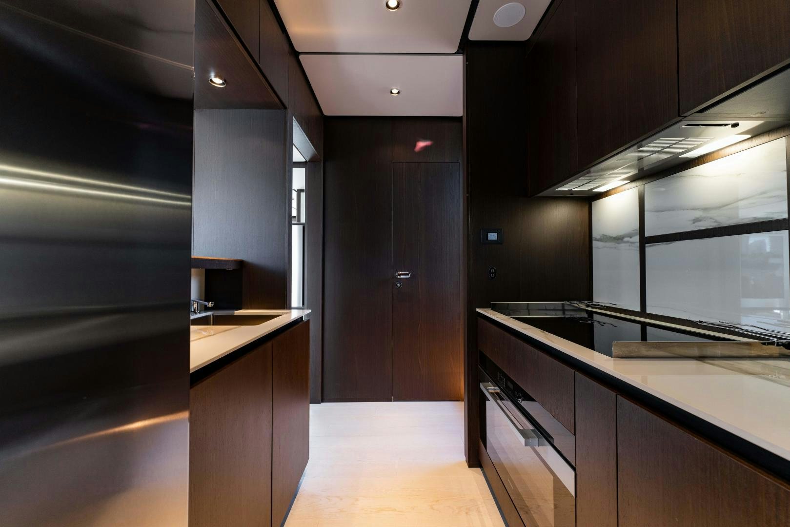 a kitchen with black cabinets aboard BESO Yacht for Sale
